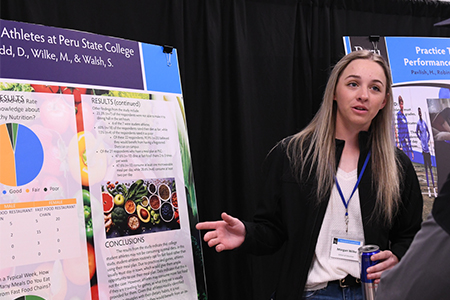 student presenting a poster