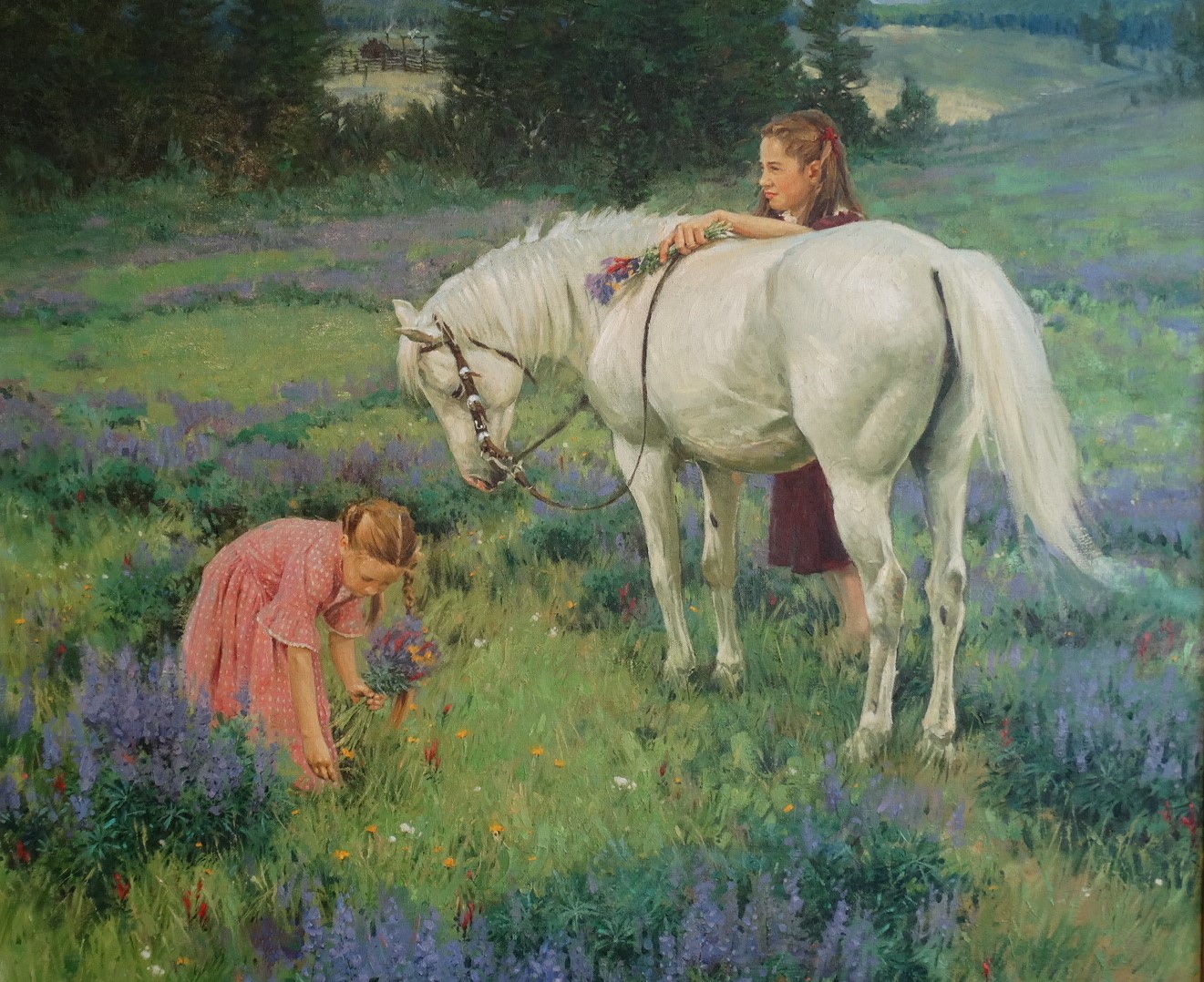 2 young girls gathering flowers in a field, older girl is holding flowers and 圣anding behind a white horse.