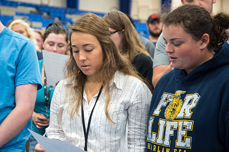 students learning the Color song at convocation