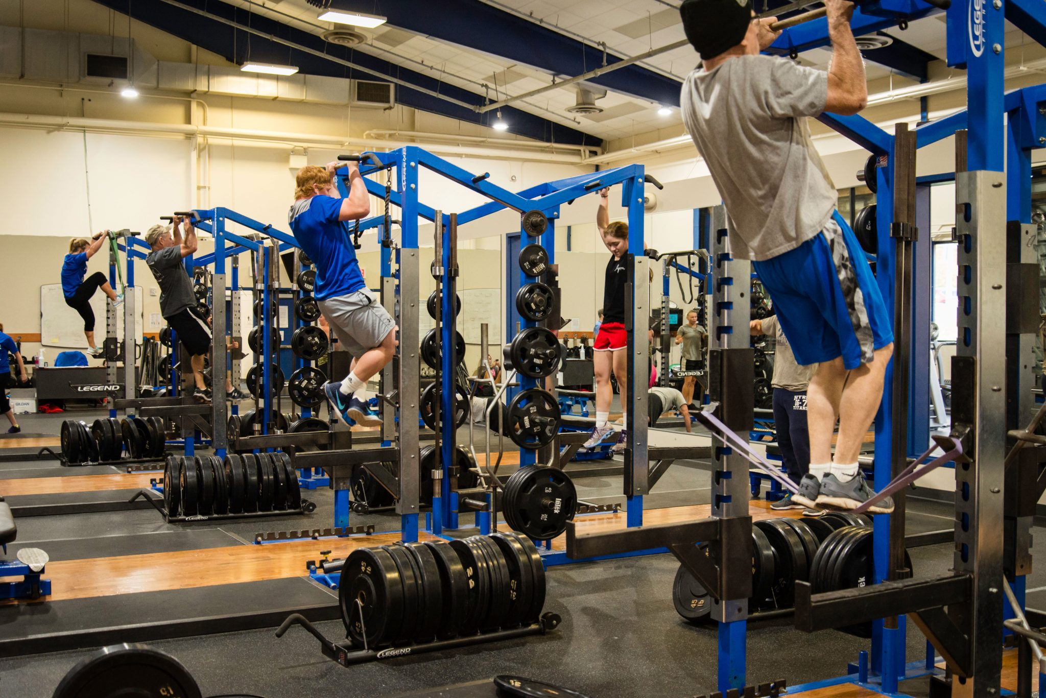 Students doing pull ups in the weight room