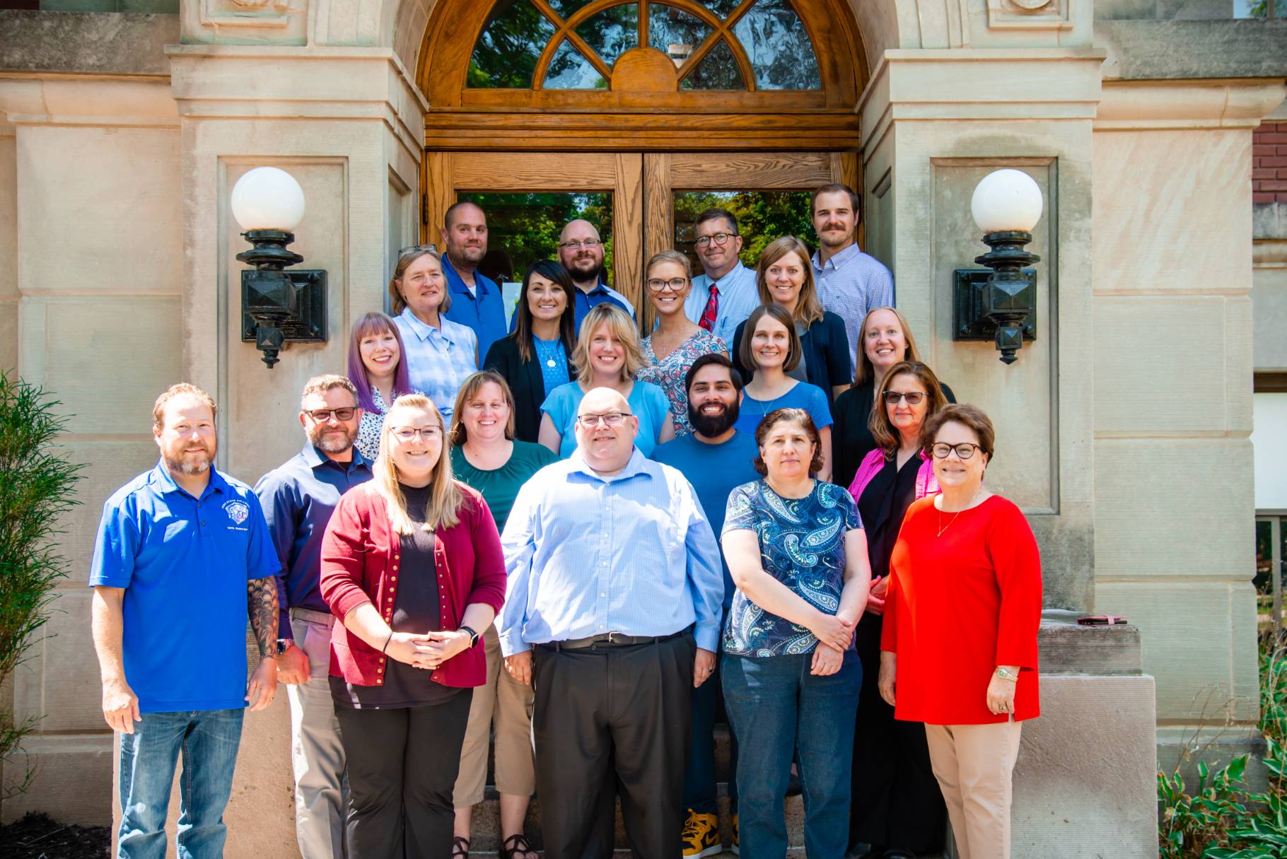 A group photo of the Education faculty and staff taken in the doorway of the TJ Majors building