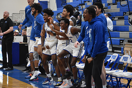 Basketball team on the sidelines of a game.