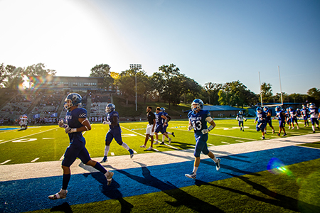 Football team running on the field.