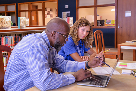 Dr. Chism meeting with a student.